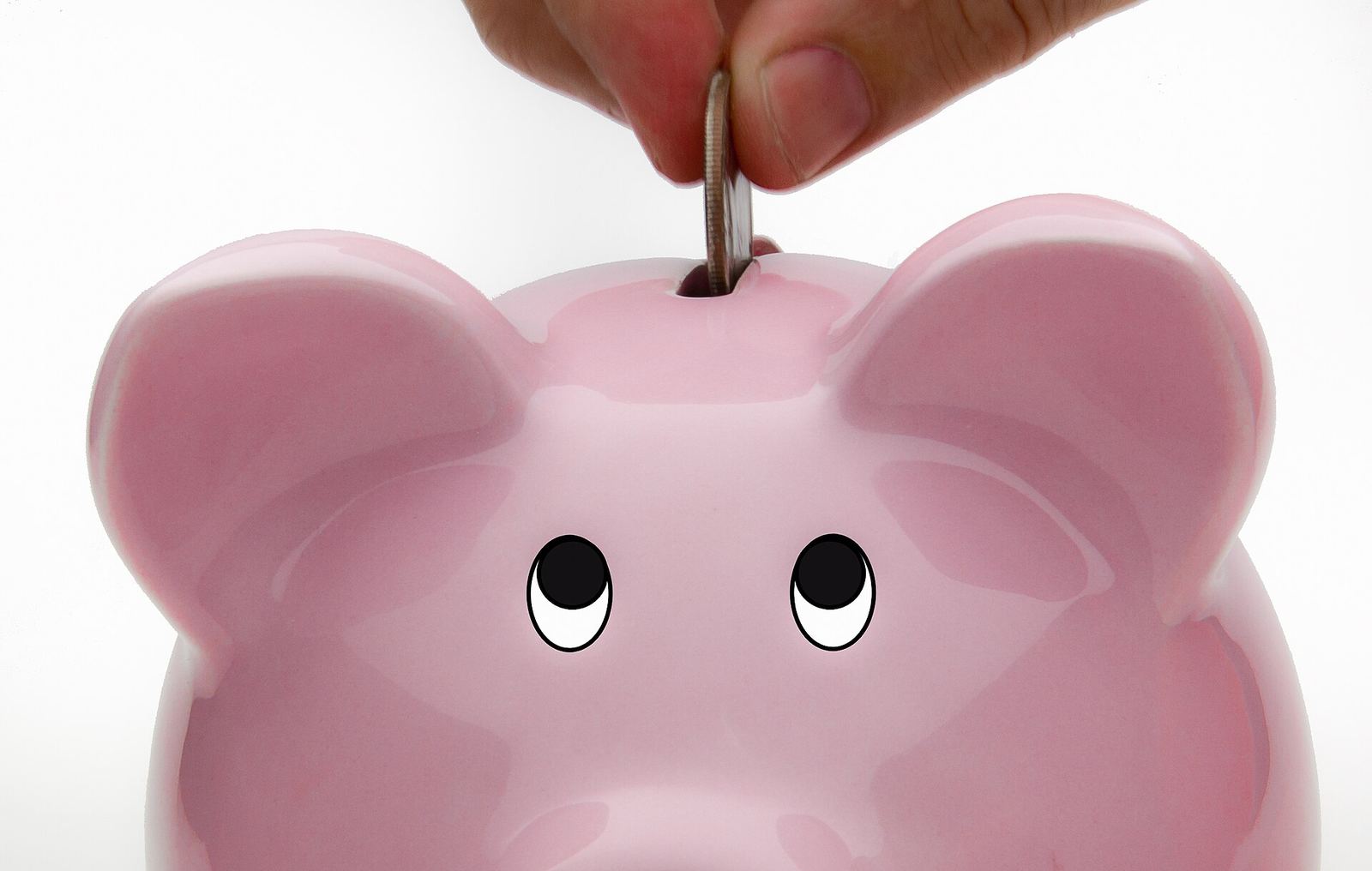 Coins saved in a glass jar, a simple stand-in for money set aside.